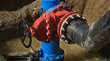 A line stop installed in an excavated space fully mitigating a water main break.