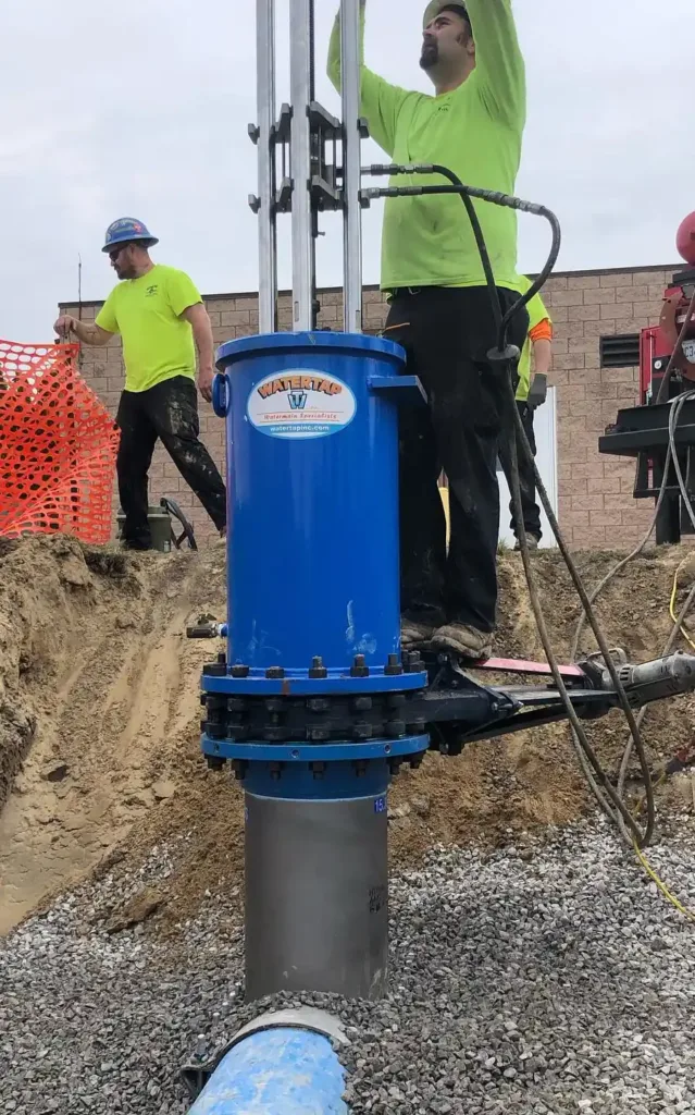 insertion valve being tapped and inserted by skilled pipeline workers from Watertap Inc.
